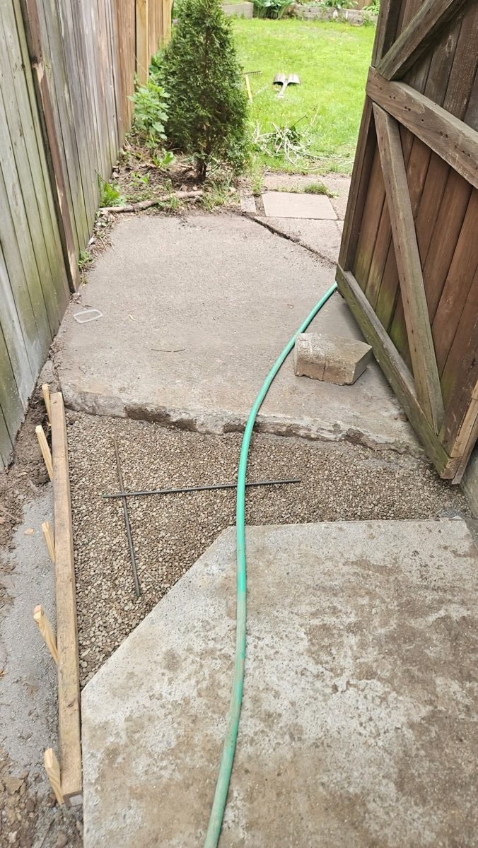 Settled, improperly pitched concrete walkway prior to correction