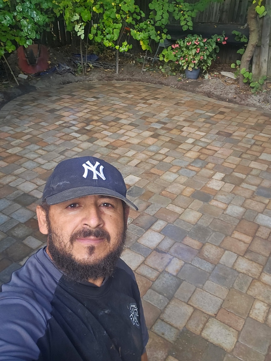 XXX Landscape owner Benito on a paver patio installation site in Ann Arbor
